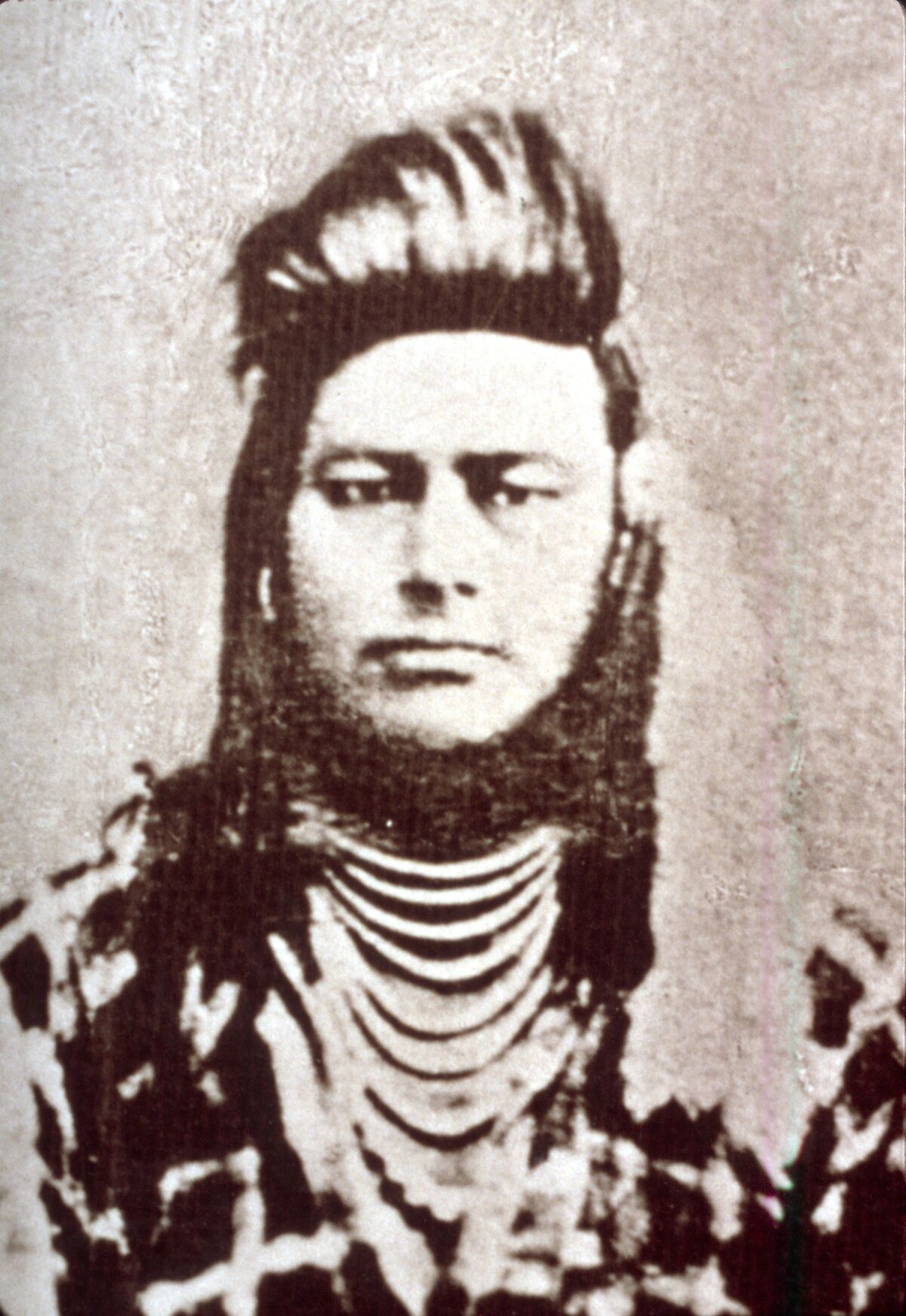 Photograph of Ollokot, closely cropped from the larger portrait in slide 035, taken in 1877 by Chas. W. Phillips in Walla Walla.