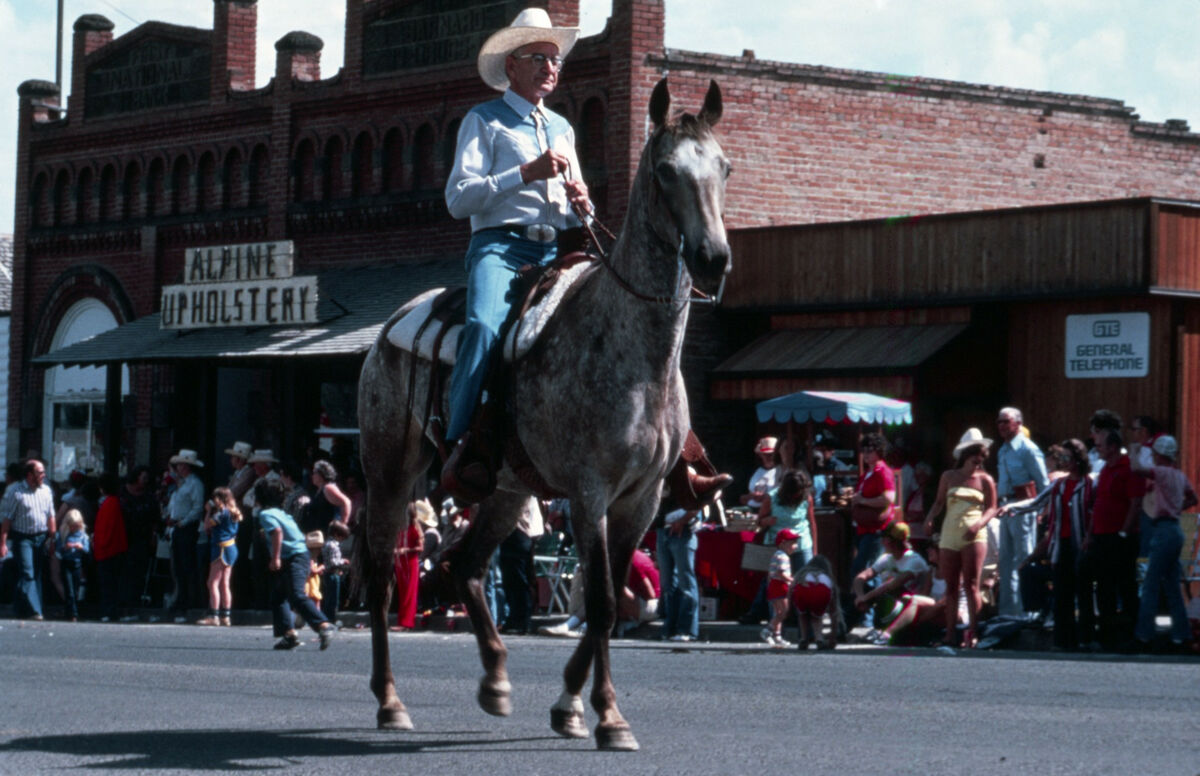 Carlyle Roundy, the Grand Marshal, rides his horse in the Chief Joseph Days parade through the town of Joseph. Taken by Janie Tippett.