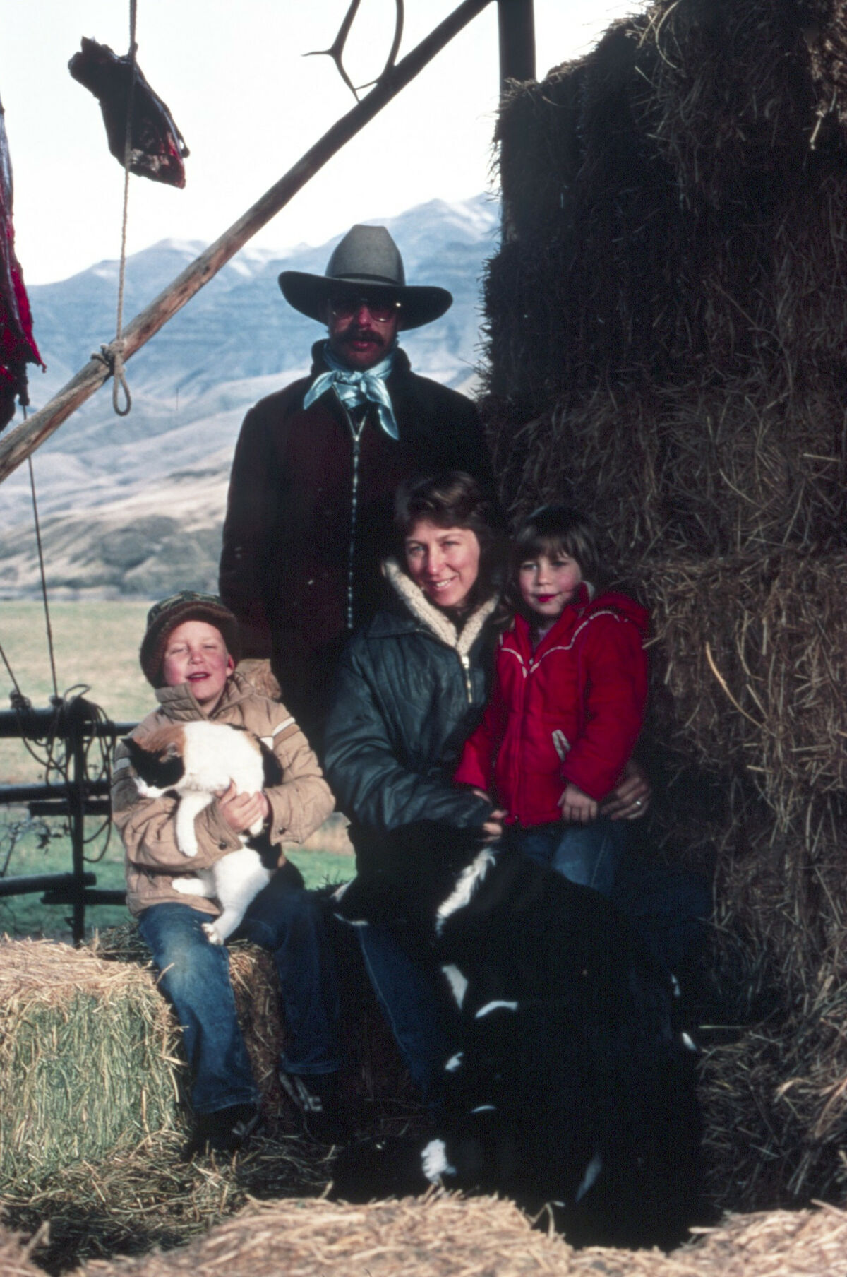 Jackie and Bill Matthews, and their children, Buck and Mona Lee, stand in the barn at the Tippett place at Dug Bar on the Snake River. Taken by Janie Tippett.