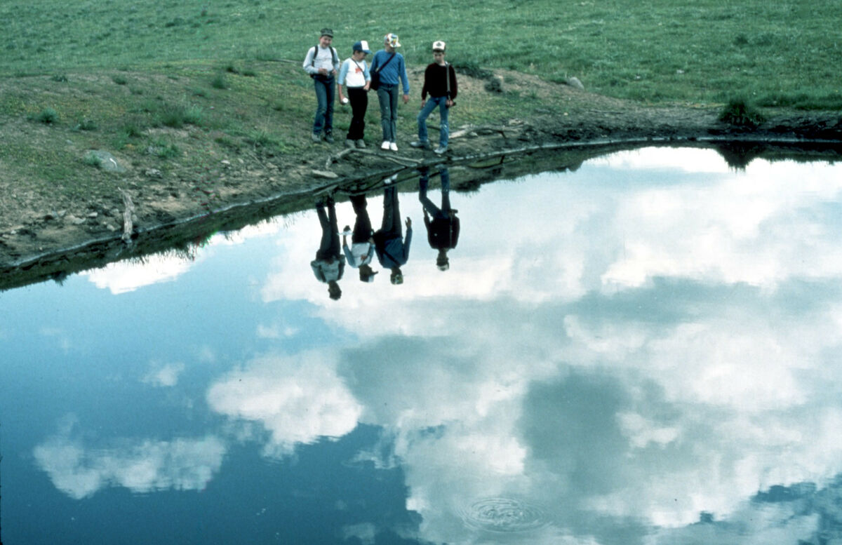 Janie Tippett’s 4-H Sourdough Shutterbugs are reflected in Kinney Lake on Upper Prairie Creek. From left are Willie Zollman, an unknown Johnson, Eric Johnson, and Ryan Hook. Taken by Janie Tippett.